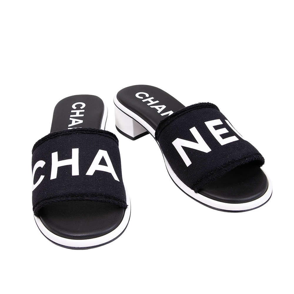 CHANEL Logo Heeled Slide Sandals in Black/White